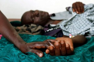 A mother holds the hand of her Aids stricken son in Rakai, Ugand